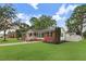 Well-manicured lawn with updated exterior featuring brick and vinyl siding, complemented by mature trees at 201 Shady Lane Dr, Smithfield, NC 27577