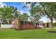 A single-story brick home with a well-kept lawn and tasteful landscaping around the perimeter at 201 Shady Lane Dr, Smithfield, NC 27577