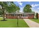 Charming brick home featuring a well-maintained lawn and classic architectural details at 201 Shady Lane Dr, Smithfield, NC 27577
