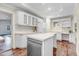 Bright kitchen with island, white cabinets, stainless steel appliances, and hardwood floors at 201 Shady Lane Dr, Smithfield, NC 27577