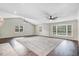 Well-lit living room featuring a plush carpet and large windows for natural light at 201 Shady Lane Dr, Smithfield, NC 27577