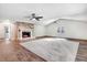 Bright living room showcases a stone fireplace and a plush neutral-colored carpet at 201 Shady Lane Dr, Smithfield, NC 27577