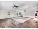 Inviting living room featuring a stone fireplace, bay window, and stylish ceiling fans at 201 Shady Lane Dr, Smithfield, NC 27577