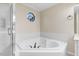 Bright main bathroom features large soaking tub, window, and lots of tile at 201 Shady Lane Dr, Smithfield, NC 27577