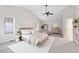 Main bedroom featuring neutral walls, ceiling fan, and multiple windows for ample natural light at 201 Shady Lane Dr, Smithfield, NC 27577