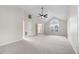 Bright main bedroom featuring vaulted ceiling, carpet, and a gorgeous arched window at 201 Shady Lane Dr, Smithfield, NC 27577