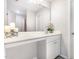 Bright bathroom featuring white vanity, white cabinets, large mirror, and decorative floral arrangement at 2040 Alderman Way, Creedmoor, NC 27522