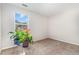 Bright bedroom showcasing a large window and a variety of colorful indoor plants at 2040 Alderman Way, Creedmoor, NC 27522