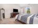Well lit bedroom features a large window, TV on dresser and blue and white bedding at 2040 Alderman Way, Creedmoor, NC 27522