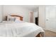 Bedroom with neutral decor, wood bed frame, and white linens for a cozy retreat at 2040 Alderman Way, Creedmoor, NC 27522