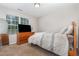 Bedroom with beige carpet, TV on wooden dresser, and window providing natural light at 2040 Alderman Way, Creedmoor, NC 27522