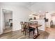 Dining area with a rustic wood table and views into the kitchen and a bedroom at 2040 Alderman Way, Creedmoor, NC 27522