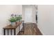 Inviting entryway with wood floors and a decorative table with potted plants at 2040 Alderman Way, Creedmoor, NC 27522