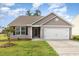 Charming single-story home featuring neutral siding, a two-car garage, and a well-manicured lawn at 2040 Alderman Way, Creedmoor, NC 27522