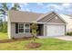 Single story home featuring neutral siding, a two-car garage, and a well-manicured lawn at 2040 Alderman Way, Creedmoor, NC 27522