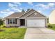 Well maintained home with manicured front lawn and an attached two car garage at 2040 Alderman Way, Creedmoor, NC 27522