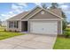 Exterior photo of a house with a garage and well-maintained lawn at 2040 Alderman Way, Creedmoor, NC 27522