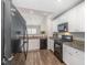 Kitchen features white cabinets, granite counters, and black appliances at 2040 Alderman Way, Creedmoor, NC 27522