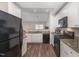 Efficient kitchen with granite counters, white cabinets, and modern black appliances at 2040 Alderman Way, Creedmoor, NC 27522