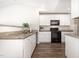 Efficient kitchen with granite counters, white cabinets, and modern black appliances at 2040 Alderman Way, Creedmoor, NC 27522
