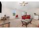 Cozy living room featuring neutral carpet, ceiling fan, large window, and comfortable seating at 2040 Alderman Way, Creedmoor, NC 27522
