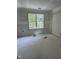 Unfinished bedroom featuring a window with views of lush trees and a closet, ready for personalization at 207 S Main St # A, Four Oaks, NC 27524