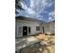 A backyard with a new concrete patio, double doors, and bare dirt ready for landscaping and lawn installation at 207 S Main St # B, Four Oaks, NC 27524