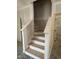 A new wooden staircase with painted risers and unfinished treads awaiting the addition of carpet or a runner at 207 S Main St # B, Four Oaks, NC 27524