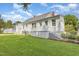 The back of the home is freshly painted white, featuring a covered patio and sprawling backyard at 2129 Wrenn St, Burlington, NC 27215