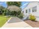 Carport with a white house featuring stairs and a well manicured yard at 2129 Wrenn St, Burlington, NC 27215
