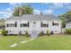 Charming home with a well-maintained lawn, stepping stone walkway, and white exterior paint at 2129 Wrenn St, Burlington, NC 27215