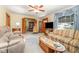 Spacious living room with wood trim, two sofas, ceiling fan, and an opening to the dining room at 2129 Wrenn St, Burlington, NC 27215