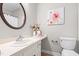 Cozy bathroom featuring a white vanity, neutral walls, and a well-lit mirror for grooming at 232 Clancy Cir, Cary, NC 27511