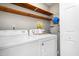 Convenient laundry room with wooden shelves and washer-dryer hookups, offering practicality and organization at 232 Clancy Cir, Cary, NC 27511