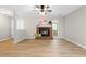 Spacious living room with hardwood floors, brick fireplace, and bright windows providing great natural light at 232 Clancy Cir, Cary, NC 27511