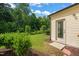 Well-maintained backyard with lush greenery, trees, and back door at 236 Lynchwick Ln, Durham, NC 27703