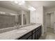 Bright bathroom featuring double sinks with granite countertops and a large mirror at 236 Lynchwick Ln, Durham, NC 27703