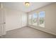 Cozy bedroom featuring neutral carpeting, natural light, and standard ceiling fixture at 236 Lynchwick Ln, Durham, NC 27703