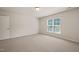 Bedroom with carpeted floors, one window, white walls and white door at 236 Lynchwick Ln, Durham, NC 27703