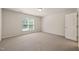 Bedroom with carpeted floors, one window, white walls and white door at 236 Lynchwick Ln, Durham, NC 27703