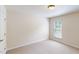 Empty bedroom features neutral carpeting, one window, and standard ceiling fixture at 236 Lynchwick Ln, Durham, NC 27703