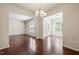 Bright dining room with beautiful hardwood floors and modern chandelier lighting fixture at 236 Lynchwick Ln, Durham, NC 27703