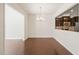 Open dining room with hardwood floors and view into the kitchen at 236 Lynchwick Ln, Durham, NC 27703