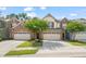 Attractive townhome exterior featuring a well-maintained lawn and a two-car garage with ample parking at 236 Lynchwick Ln, Durham, NC 27703