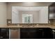Granite countertop with stainless steel appliances and dark cabinets in this modern kitchen at 236 Lynchwick Ln, Durham, NC 27703