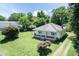 This charming home is surrounded by mature trees and has a spacious yard, partially fenced, with a long driveway at 310 Spring St, Durham, NC 27703
