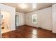 Bedroom featuring hardwood floors, natural light from window, and access to bathroom at 310 Spring St, Durham, NC 27703
