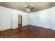 Spacious bedroom featuring hardwood floors, decorative wallpaper, and classic ceiling fan at 310 Spring St, Durham, NC 27703