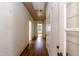 Hallway featuring hardwood floors and white trim, leading to various rooms at 310 Spring St, Durham, NC 27703