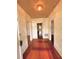 Hallway with hardwood flooring, doors and white trim, and textured wallpaper at 310 Spring St, Durham, NC 27703